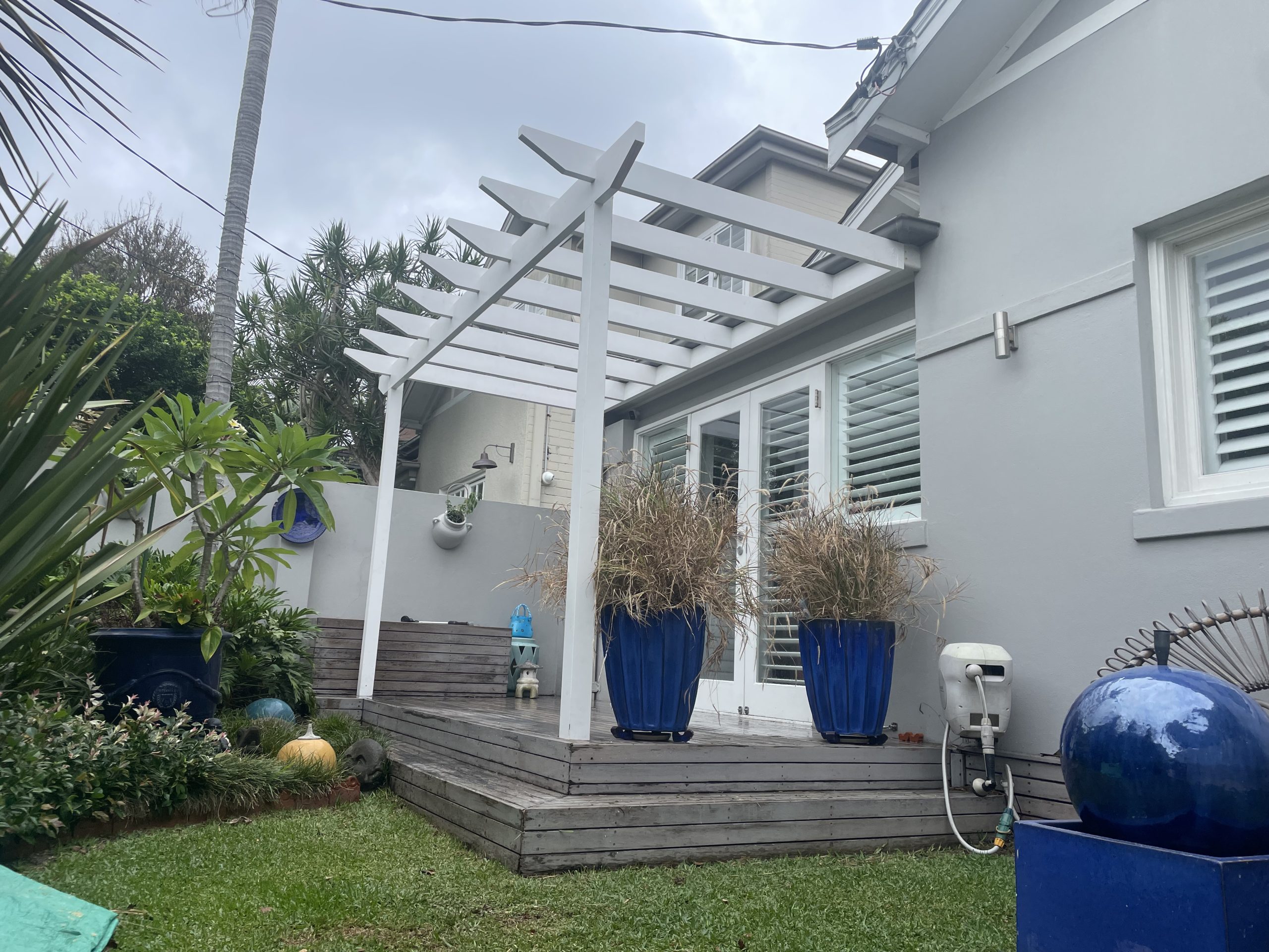 White open pergola over a deck