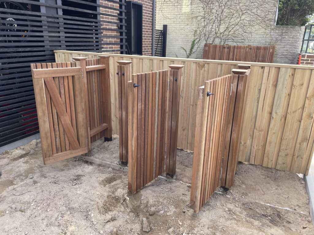 Spotted gum wheelie bin enclosures on both sides of a Bronte duplex