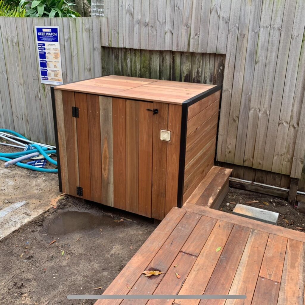 Spotted gum pool filter enclosure with black aluminium trim to match the deck, Bondi