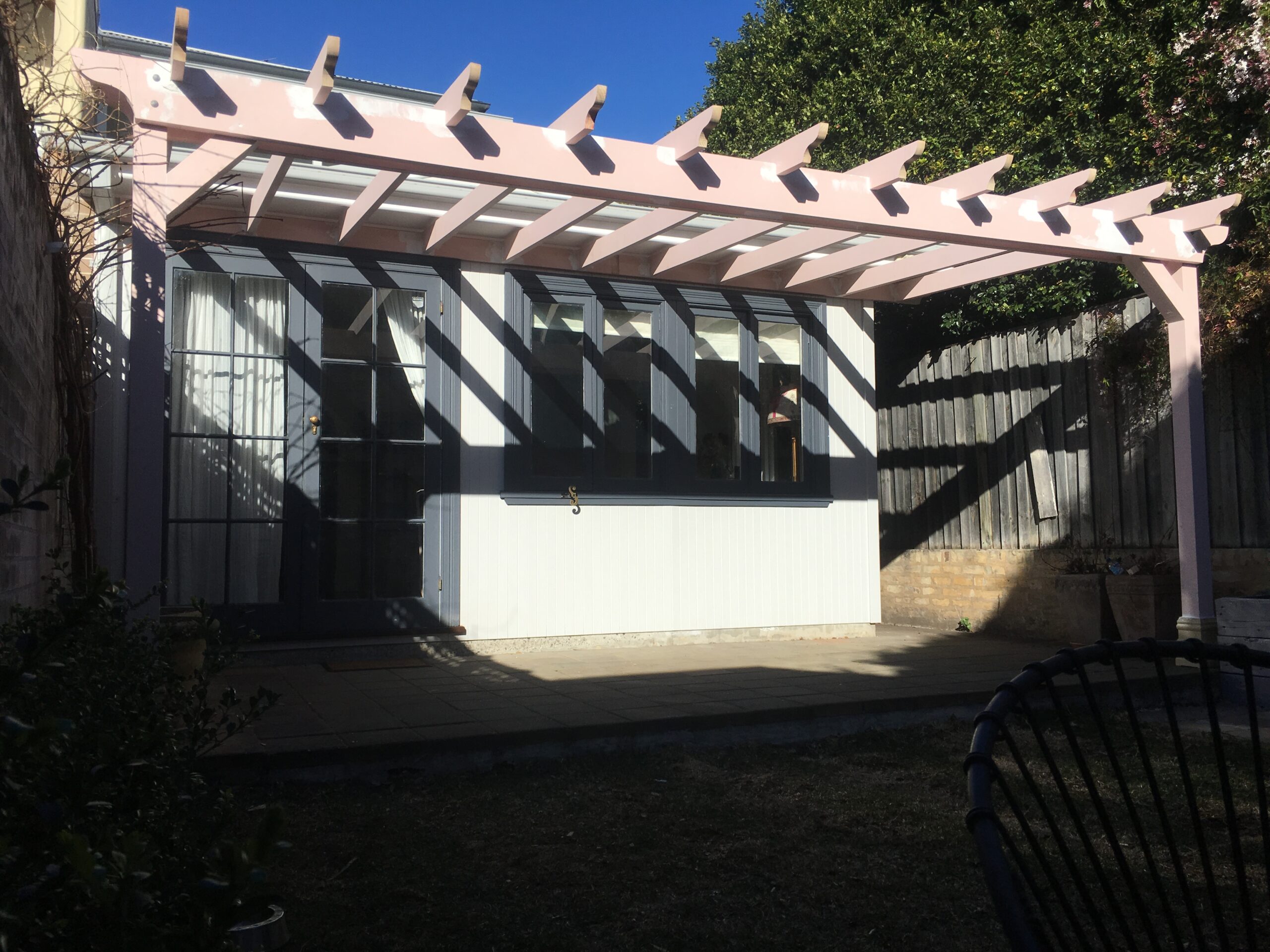 Open timber pergola on a house wall