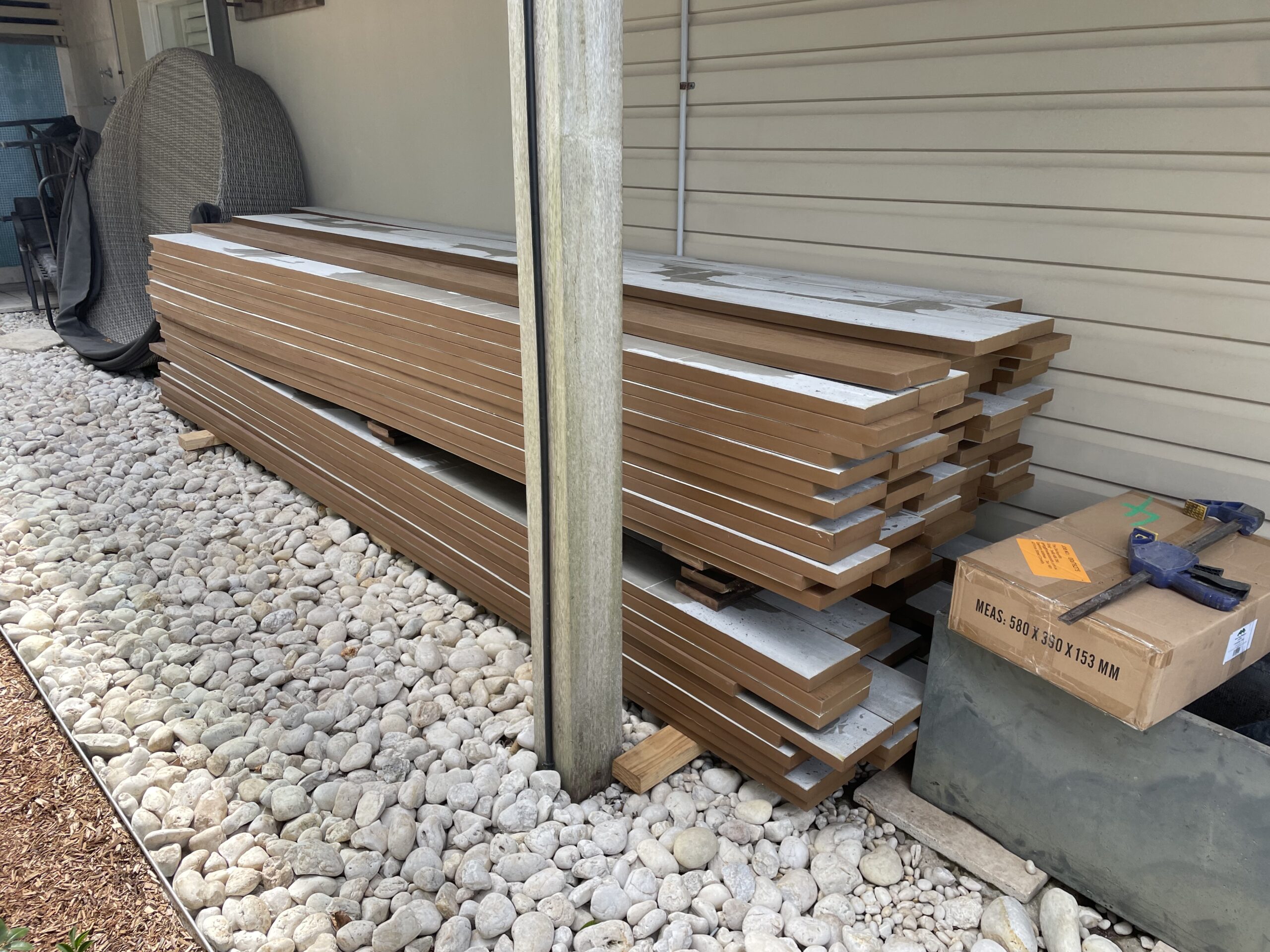 Millboard boards on site acclimating three days ahead, Clovelly pool deck — The Decksmith
