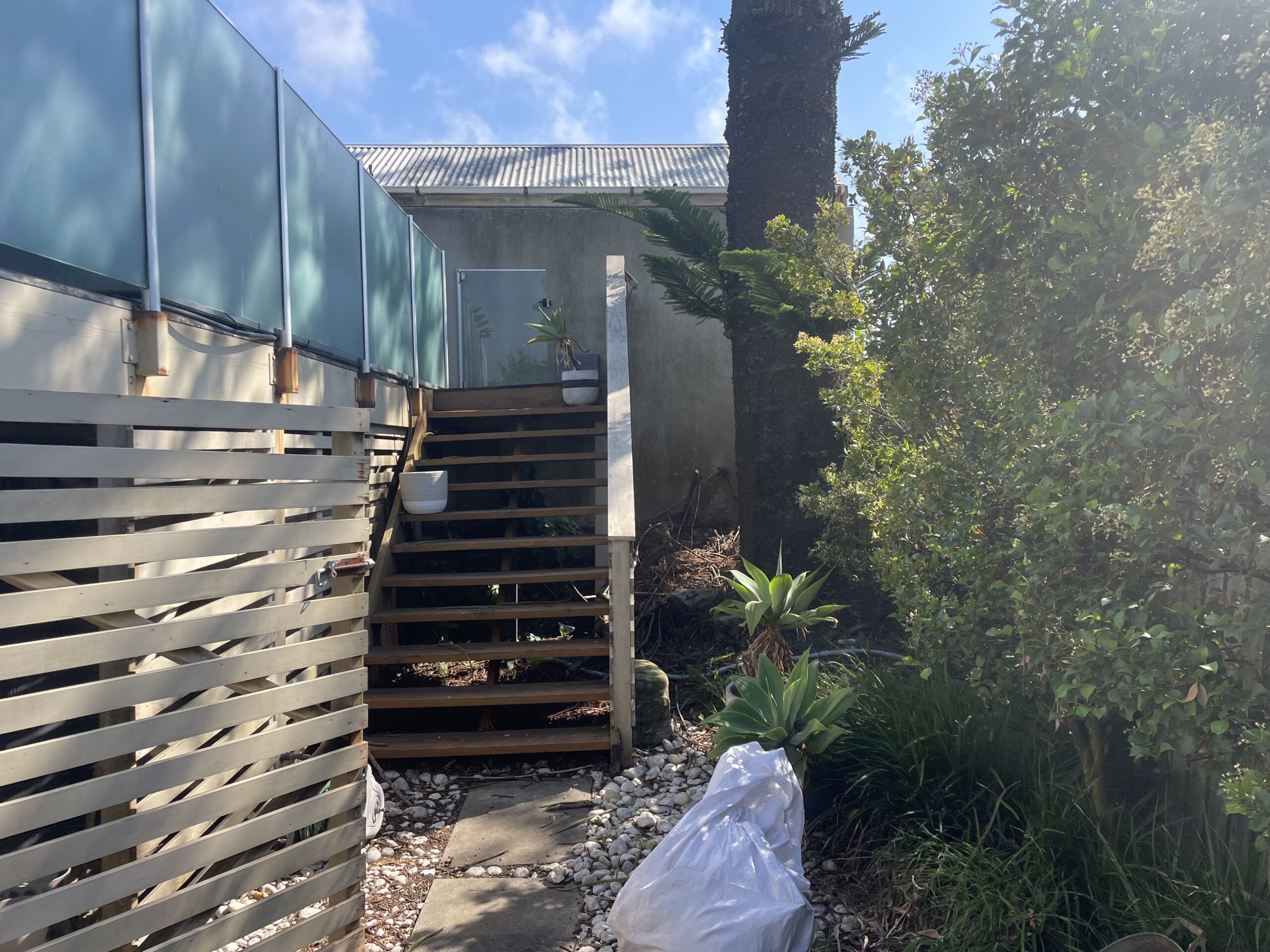 Existing steps wasting space before removal, Clovelly pool deck — The Decksmith