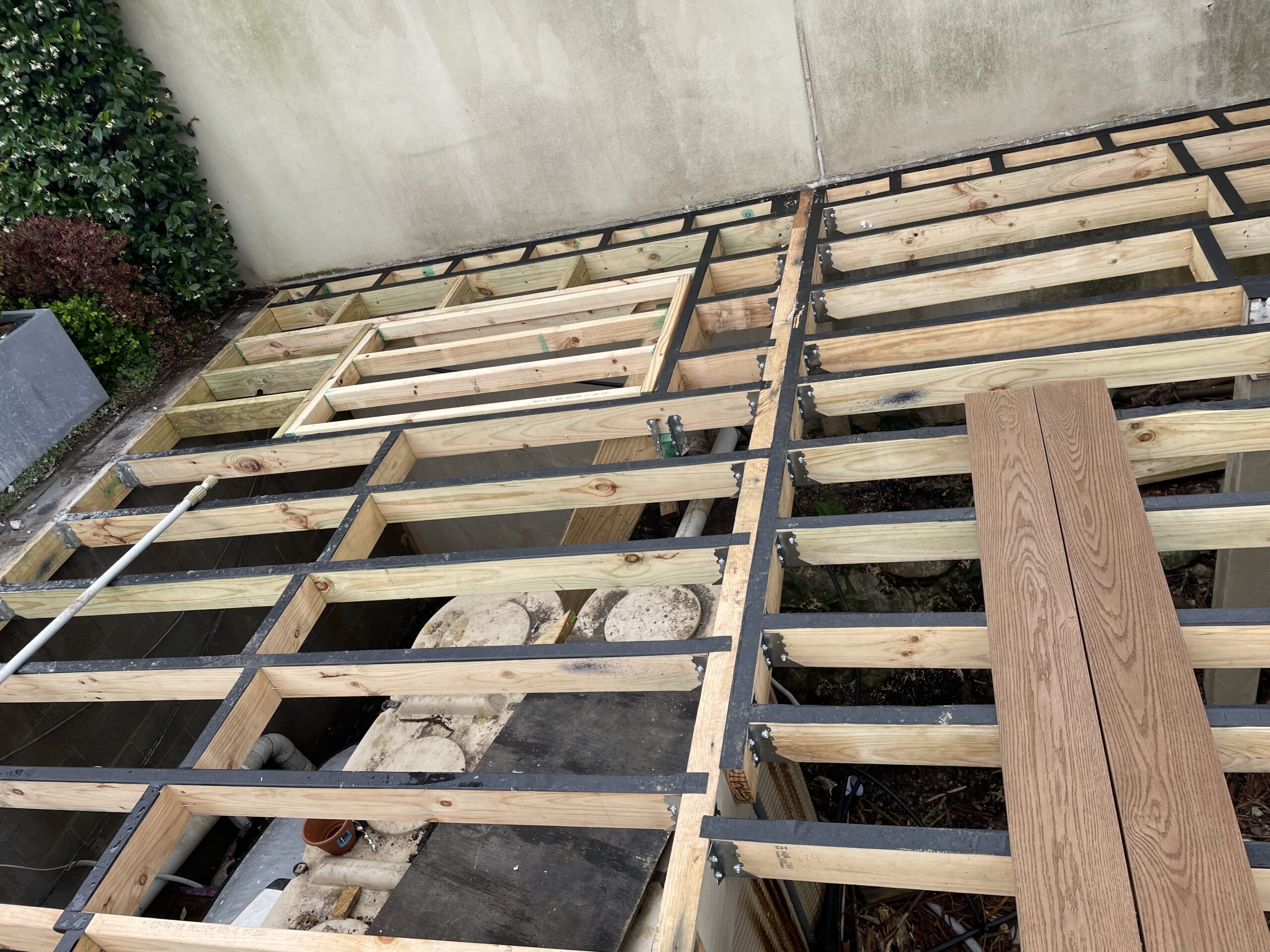 Frame taped with joist hangers set and trap door built, Clovelly pool deck — The Decksmith