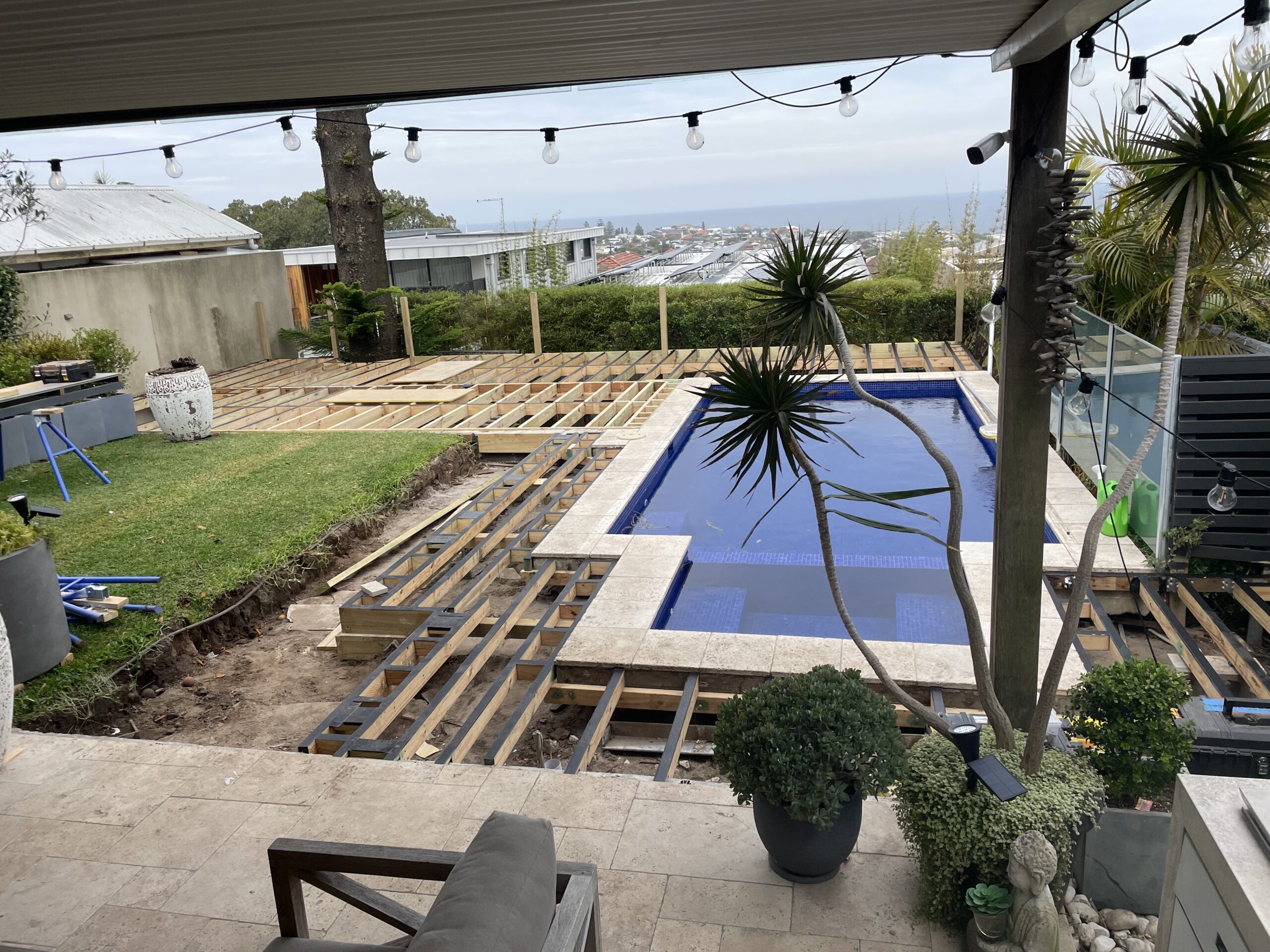Joist protection tape application started on frame, Clovelly pool deck — The Decksmith