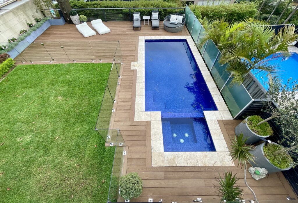 Millboard composite deck bordering a pool with new lawn, Clovelly