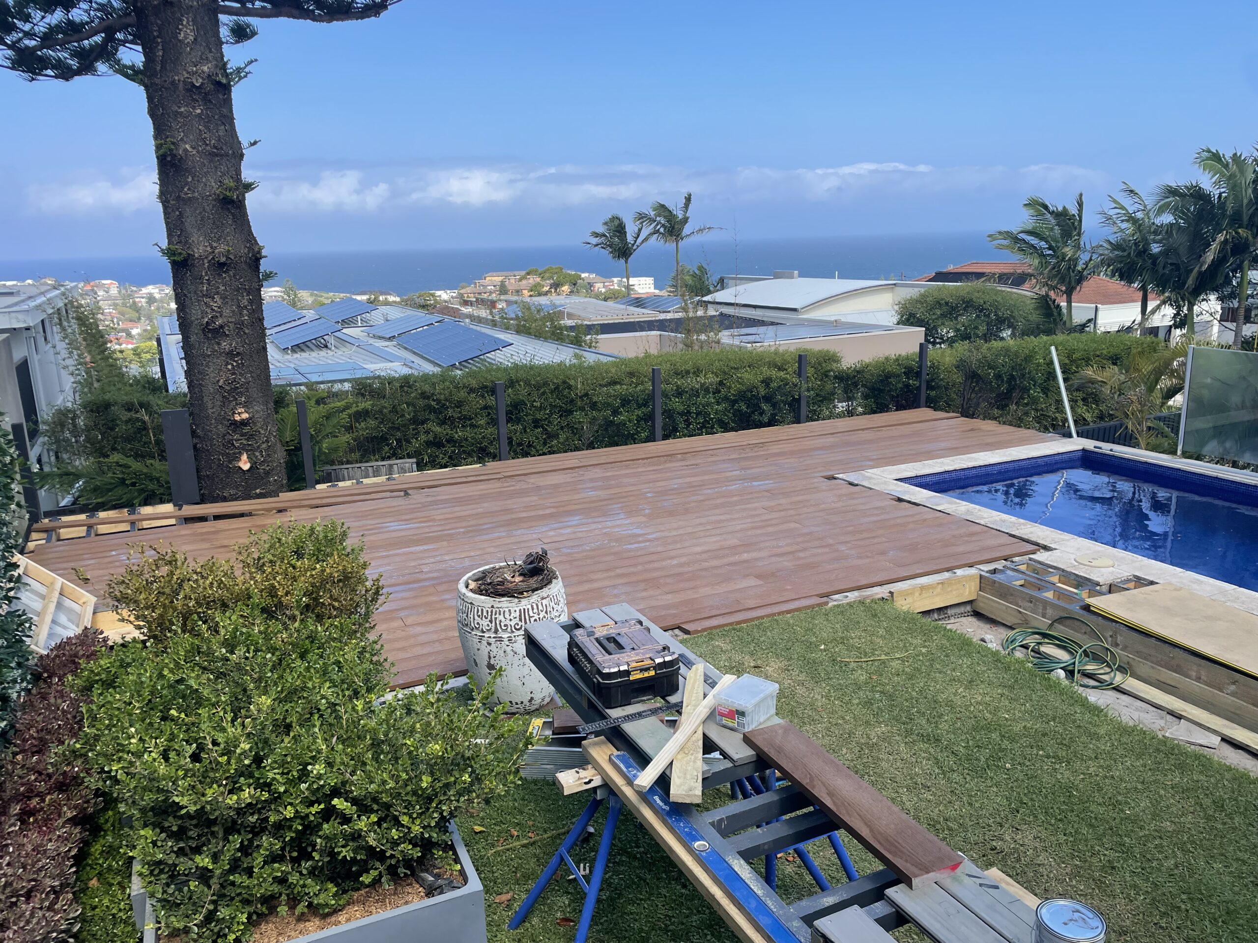End-of-day site clean during build progress, Clovelly pool deck — The Decksmith