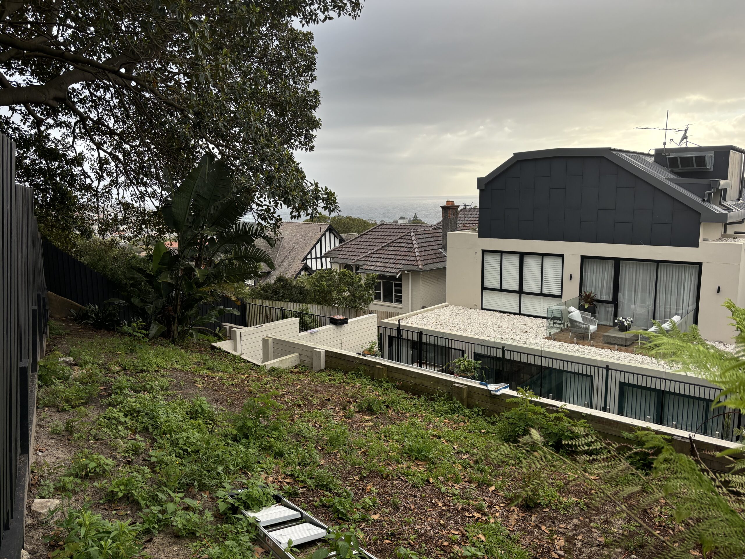 Before photo of barren steep hillside in Coogee NSW prior to luxury deck construction by The Decksmith