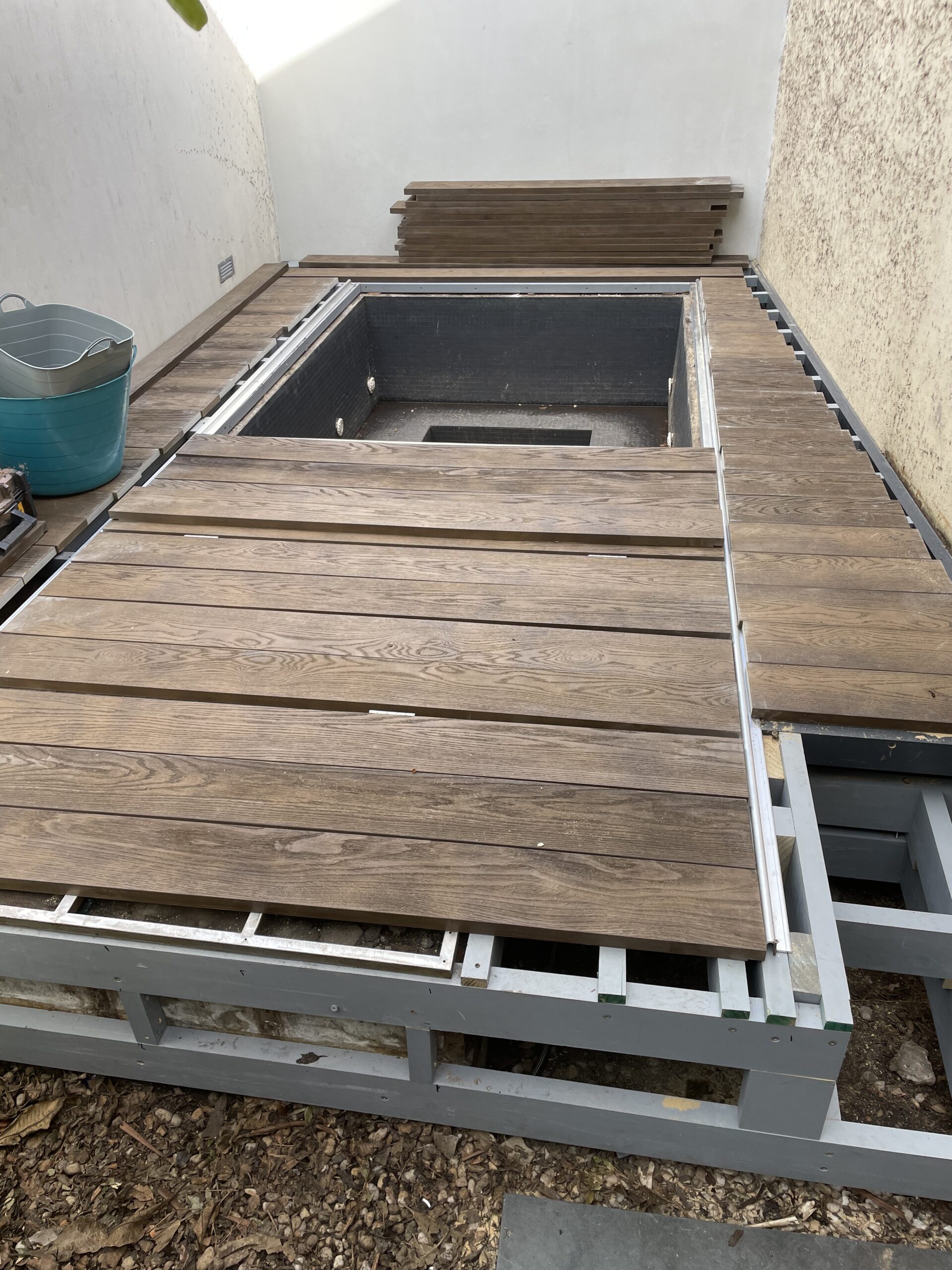 Millboard Lowdeck sliding pool cover decking installation — low-clearance spa deck in Paddington