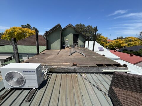Deck boards lifted during demolition, Mascot rooftop