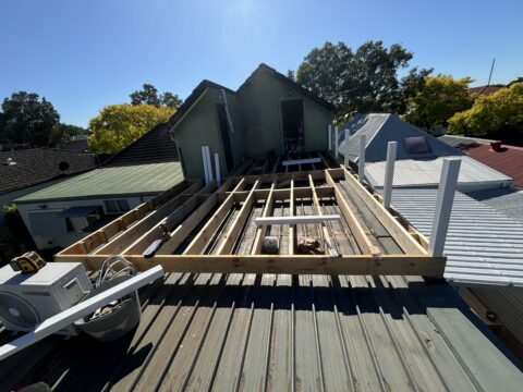H3 treated pine deck framing begins on Mascot rooftop