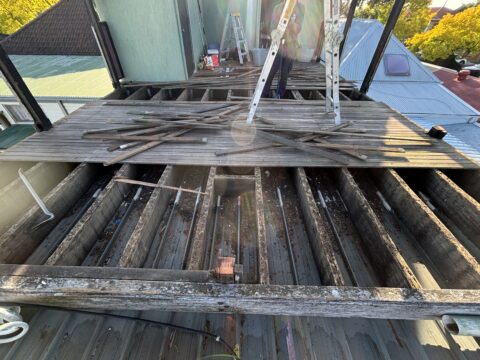 Shade tarp rigged on hot Colorbond rooftop during Mascot demolition