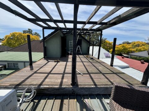 Old pergola frame demolition on Mascot rooftop