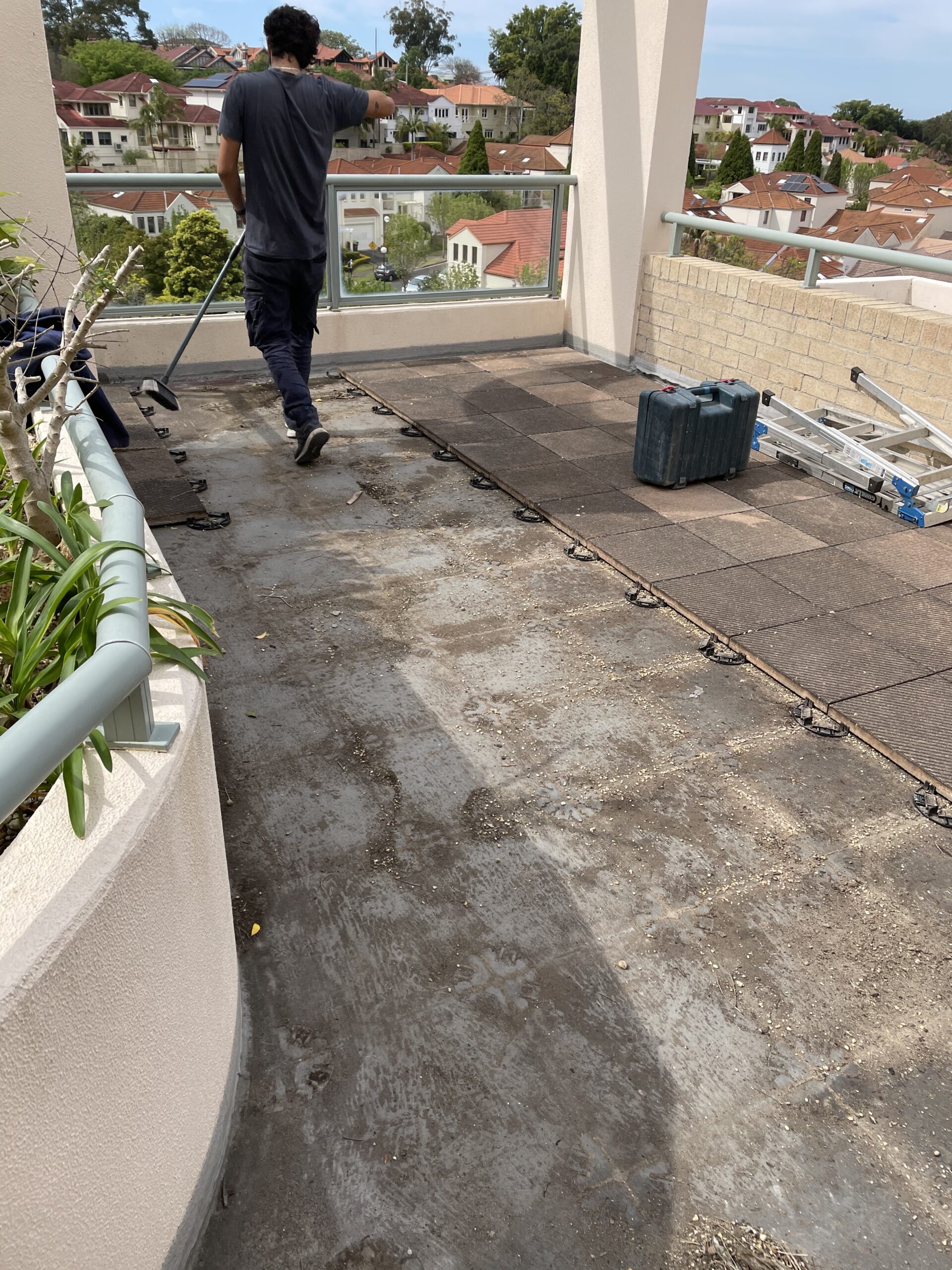 Trex lowdeck pedestal with breaker boards Kensington Before slab cleaning — floating rooftop balcony deck in Kensington