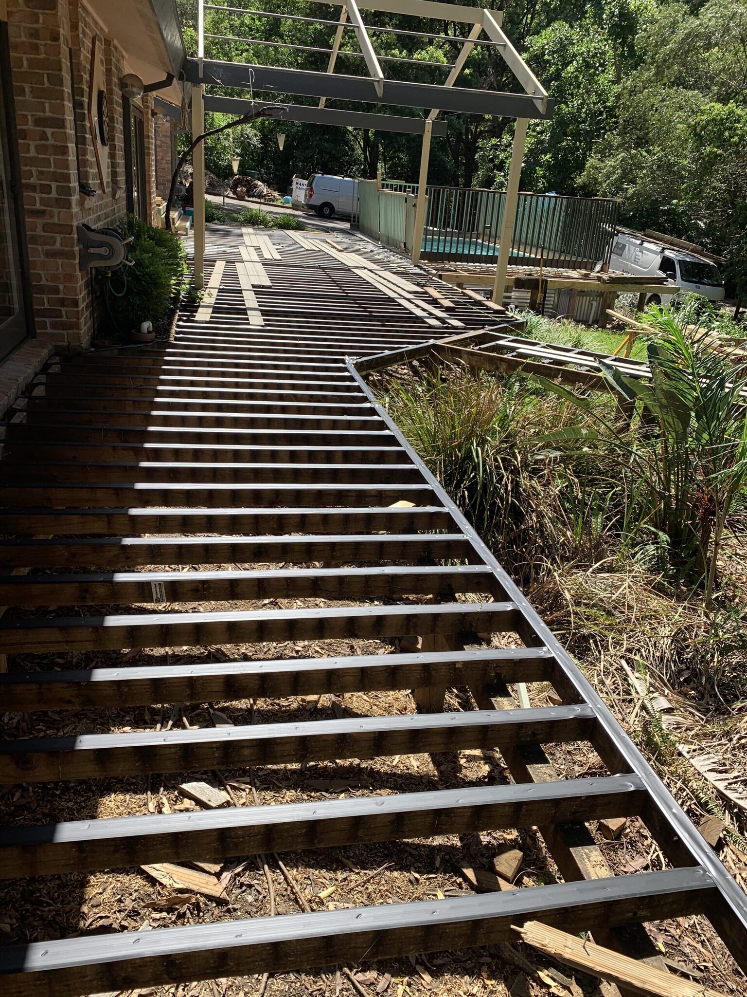 Joists taped up — protection before anything goes back on top.