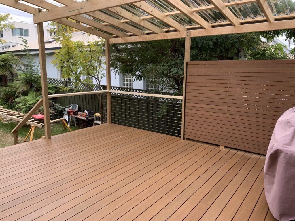 NewTechWood Teak deck with privacy screen, stainless cable balustrade and pergola.