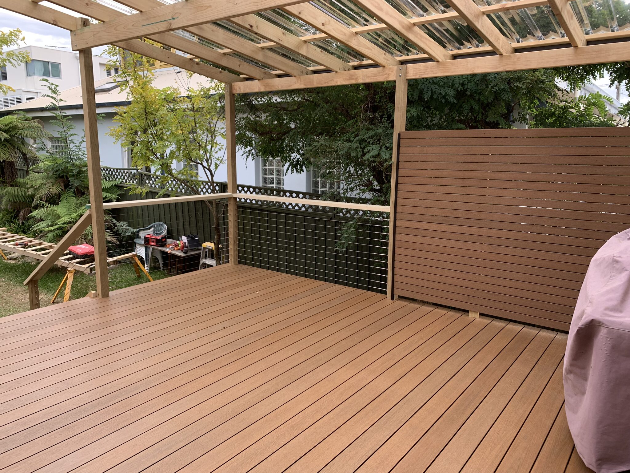 NewTechWood Teak deck with privacy screen, stainless cable balustrade and pergola.
