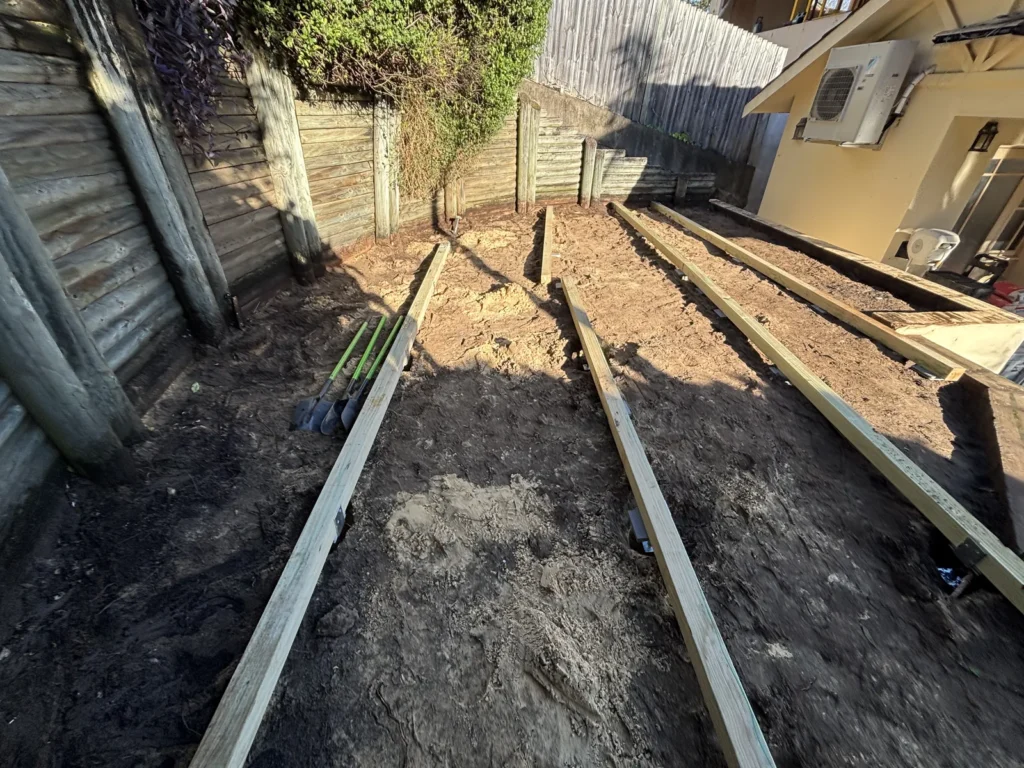 Treated pine bearers set on packers over excavated ground, Double Bay deck build