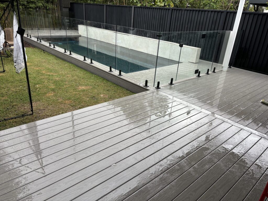 Glass fence installed, done — Kingsford WoodEv pool deck complete
