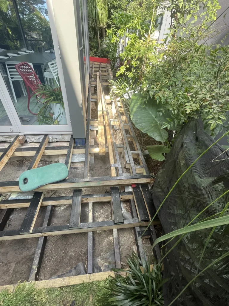 H4 90x90 post acting as a retainer at Kyogle Street Maroubra, with the low framing coated in bitumen in-ground timber protector
