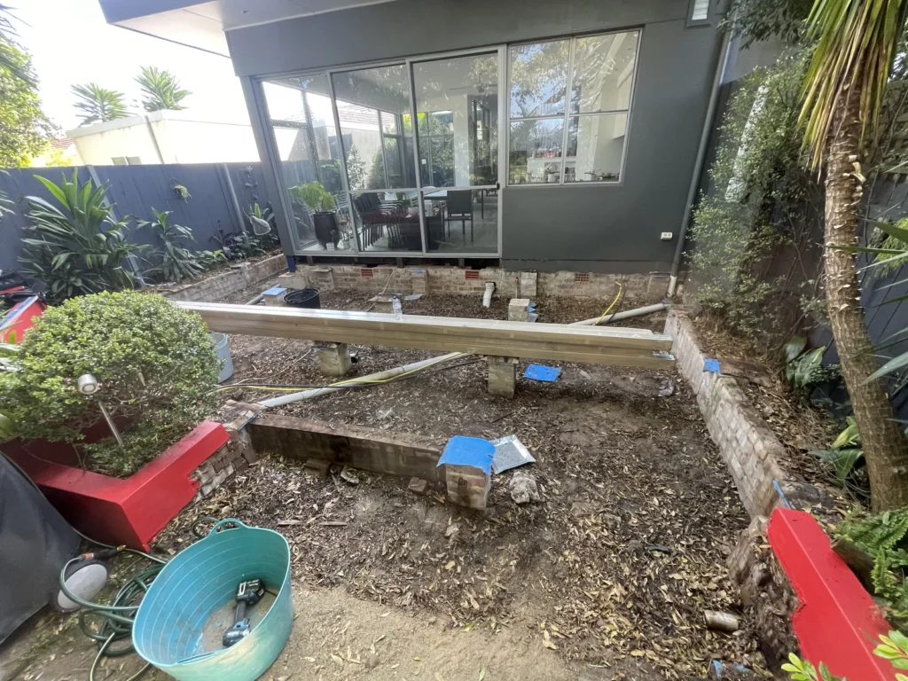 Strip-out at Kyogle Street Maroubra with the first new bearer set to level on the existing brick piers