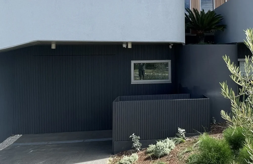 Finished bin and scooter store in Maroubra painted to match the garage door so it reads as wall from the street