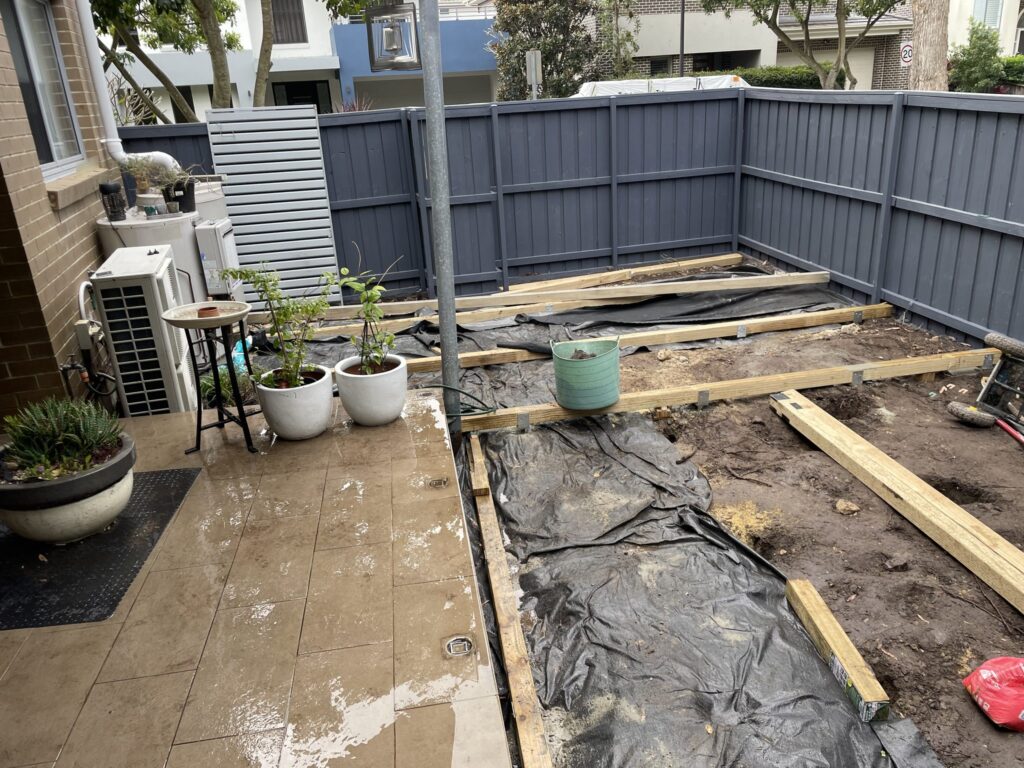 Matraville courtyard prepared for a low-clearance deck, excavated and levelled with weed matting laid