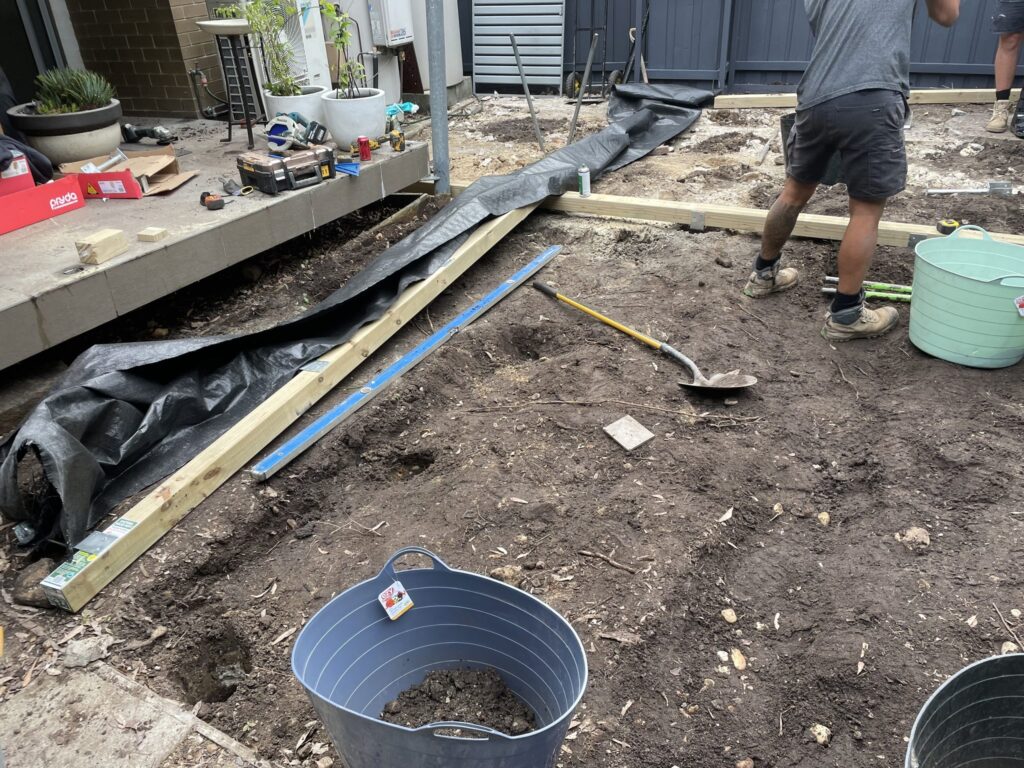 Excavated courtyard in Matraville with perimeter framing set out over rocky ground before low deck construction