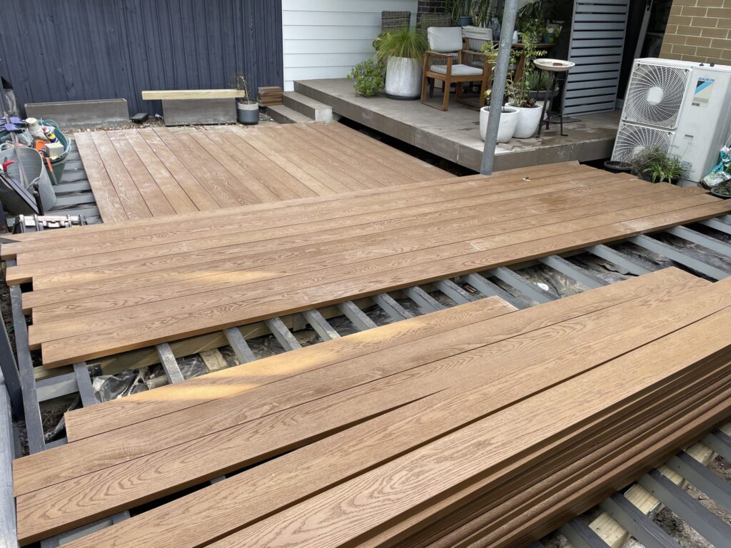 Millboard boards set out running in opposing directions across two levels of a Matraville deck