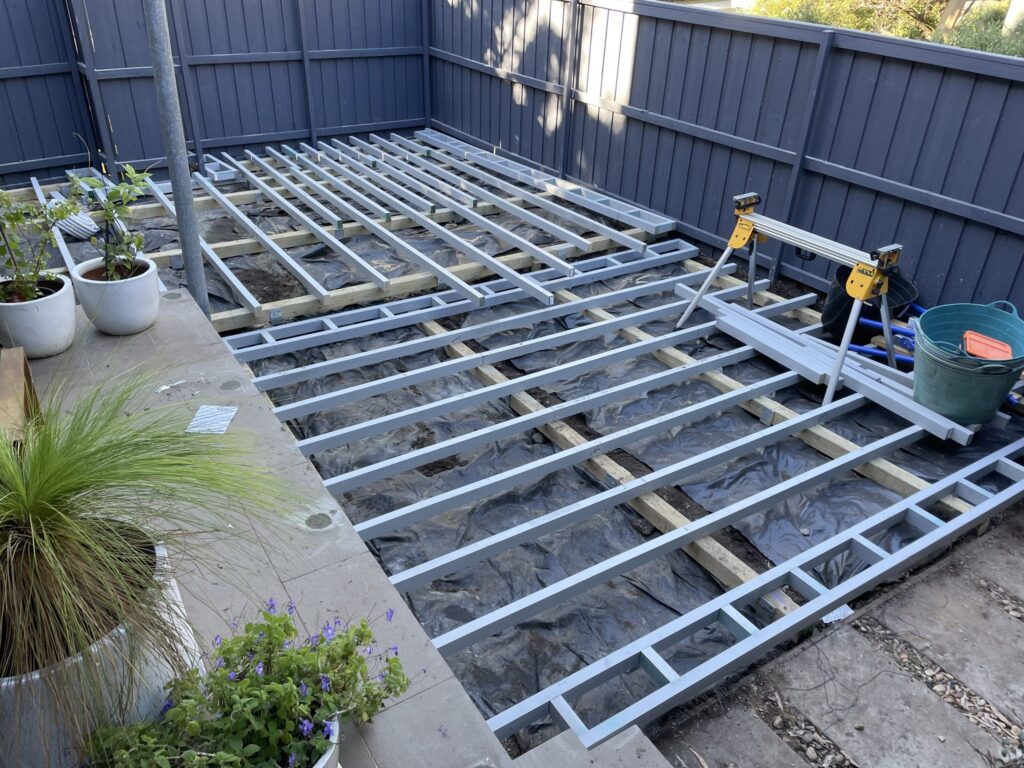 Millboard Lowdeck H4-rated subframe laid out across a Matraville courtyard over excavated ground