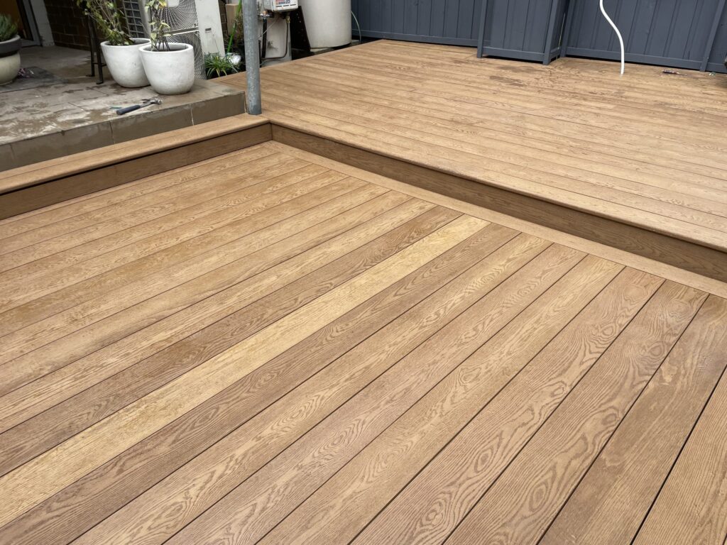 Millboard running step joining two levels of a split-level deck in Matraville