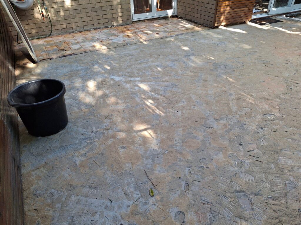 Courtyard slab exposed after tile removal, ready for ClickDeck aluminium framing, Neutral Bay